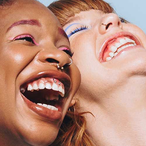 Two colourful people laughing