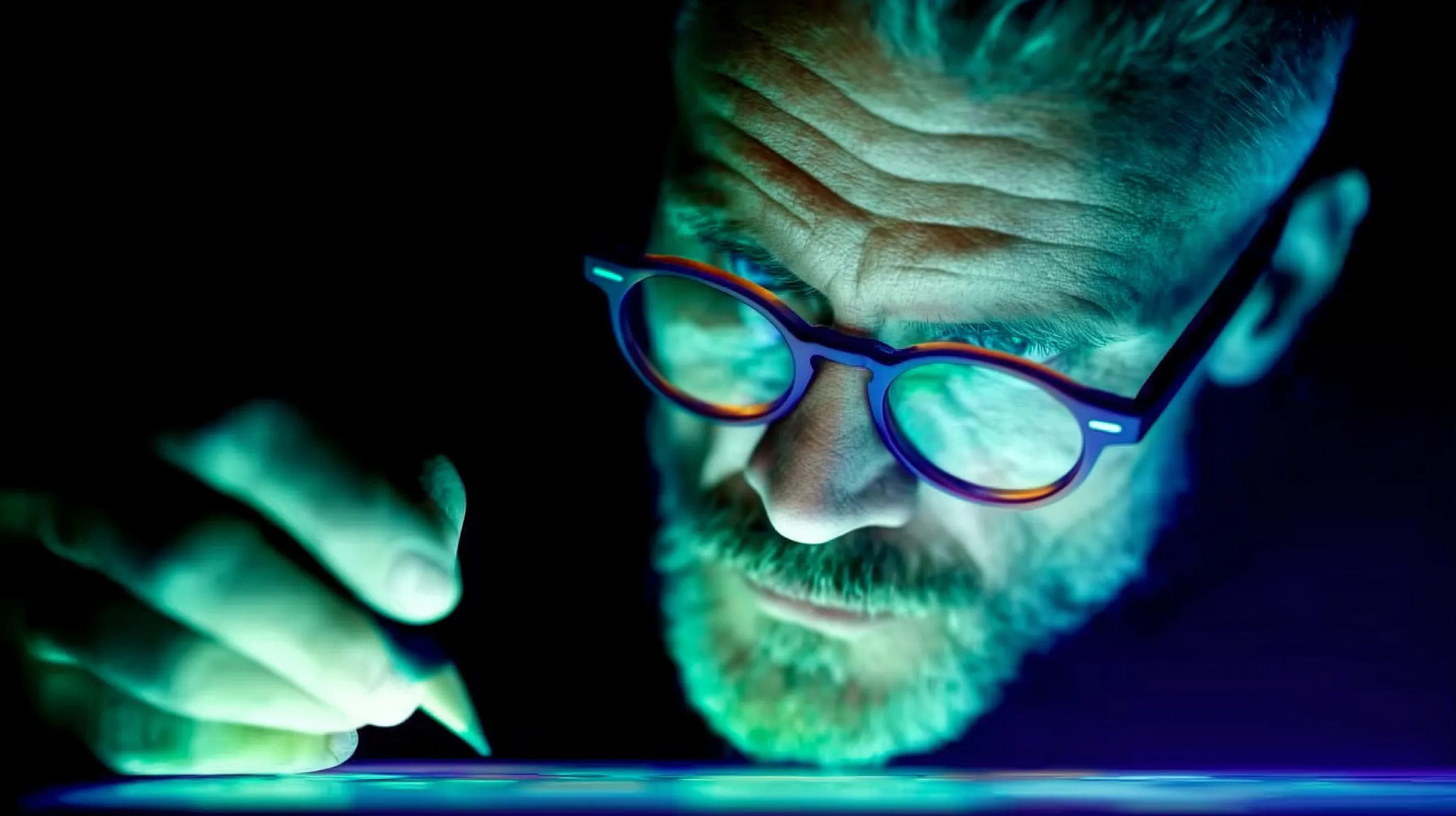 Stylistic close-up of mans face concentrating on writing