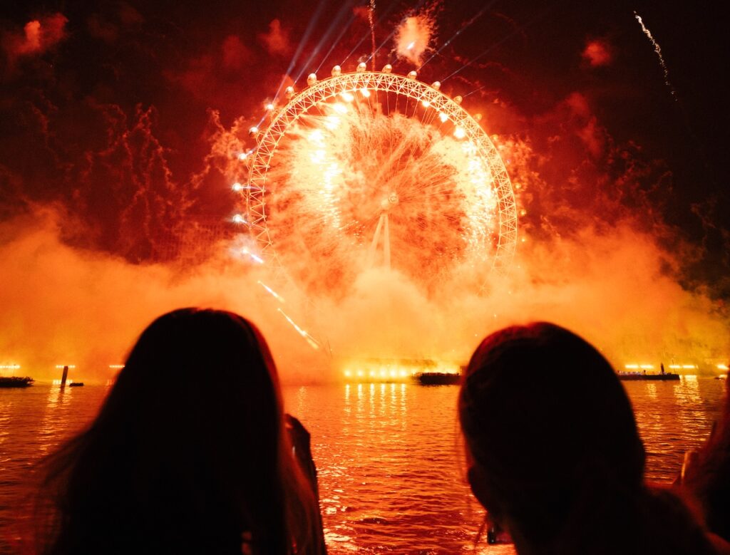 London NYE fireworks with people in foreground
