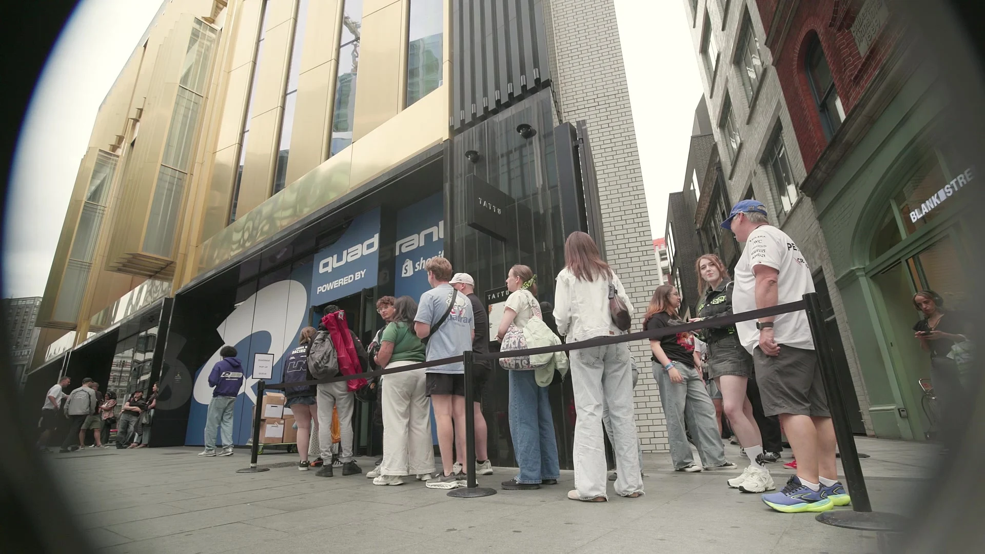 Fans queue outside the Quadrant x Shopify pop-up at The Now Building at Outernet London