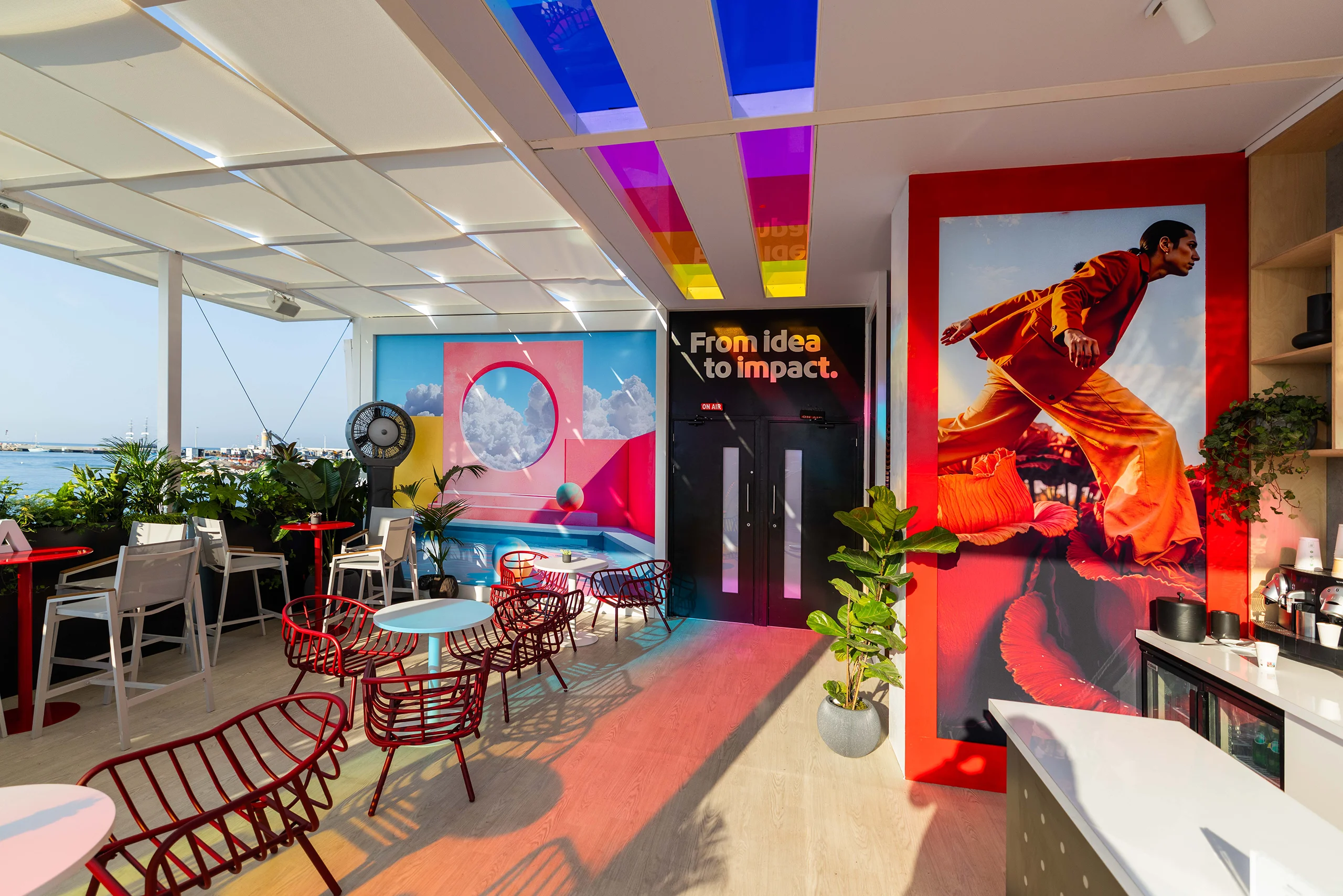 Colourful Adobe lounge with creative artwork, seating areas and branded interiors