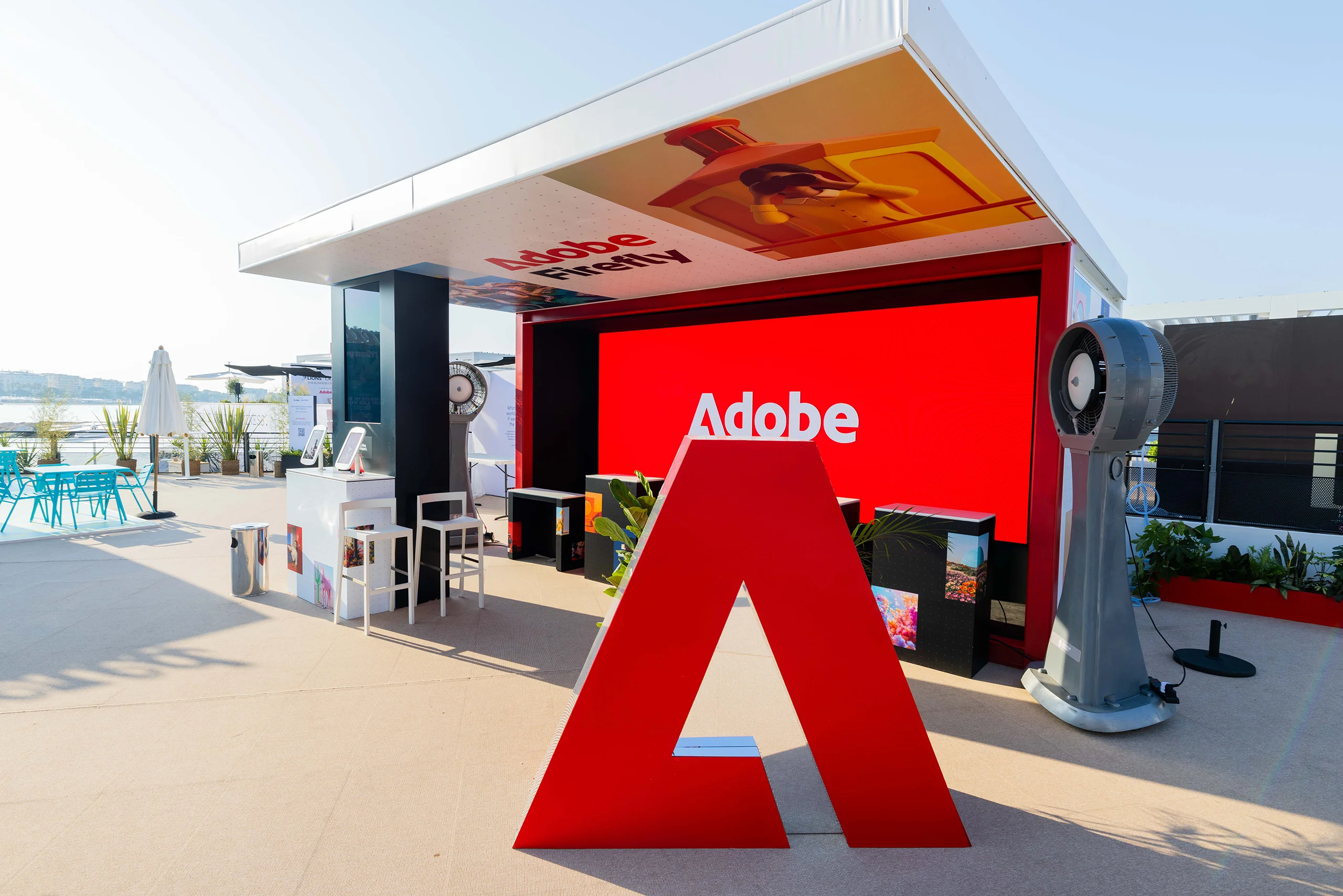 Large red Adobe A sculpture outside a branded hospitality space at Cannes Lions