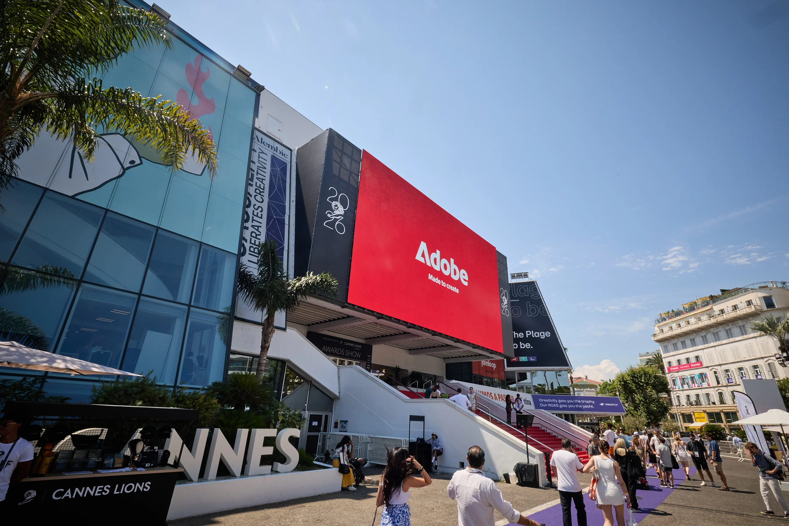 Large red Adobe digital billboard overlooking the Cannes Lions festival entrance